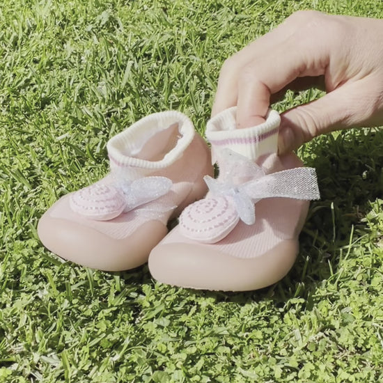 Showcasing pink lollipop children's shoes 